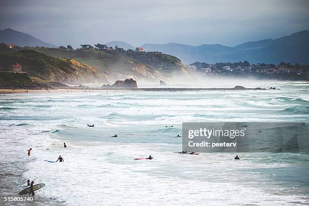 surfers at the beach. biarritz, france. - biarritz stock pictures, royalty-free photos & images