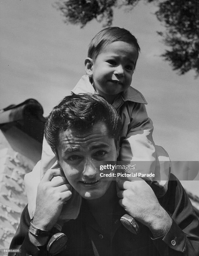 Portrait of actor John Derek, with his young son Russell on his