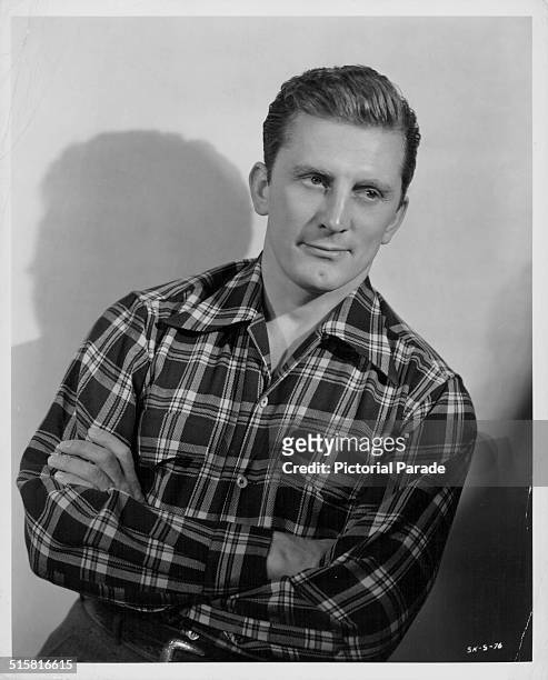 Portrait of actor Kirk Douglas wearing a check shirt, circa 1940.
