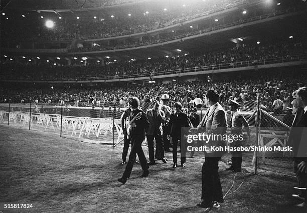 John Lennon and Ringo Starr of The Beatles running toward the stage at Dodger Stadium, Los Angeles, California, August 28, 1966.