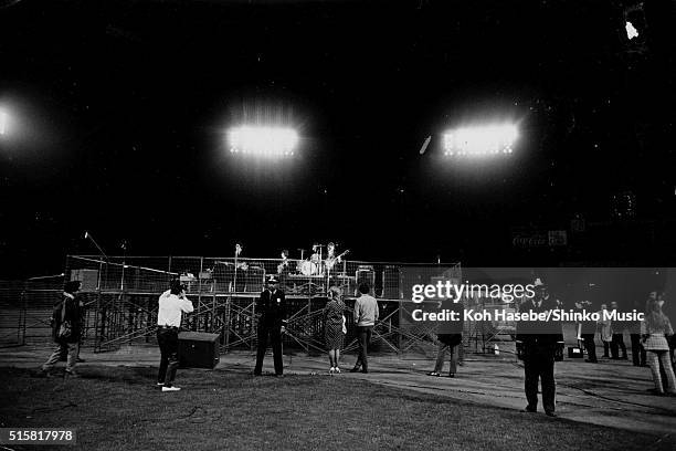 Police officers stand as security in front of the stage while The Beatles play the last show of their final tour at Candlestick Park, San Francisco,...