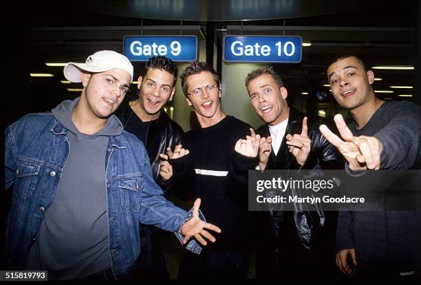 Boy band Five pose together at an airport in Sweden, 2001. The band includes Jason Brown, Abz Love, Sean Conlon, Ritchie Neville and Scott Robinson.