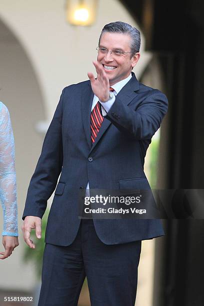 Governor of Puerto Rico, Alejandro Garcia Padilla waving to people while waiting the arrival of King Felipe VI and Queen Letizia of Spain during...