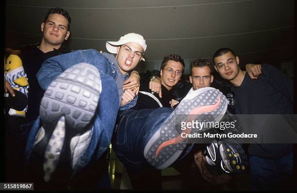 Boy band Five pose together at an airport in Sweden, 2001. The band includes Jason Brown, Abz Love, Sean Conlon, Ritchie Neville and Scott Robinson.
