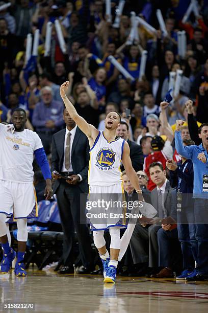 Stephen Curry of the Golden State Warriors celebrates on the bench during their game against the Oklahoma City Thunder at ORACLE Arena on March 3,...