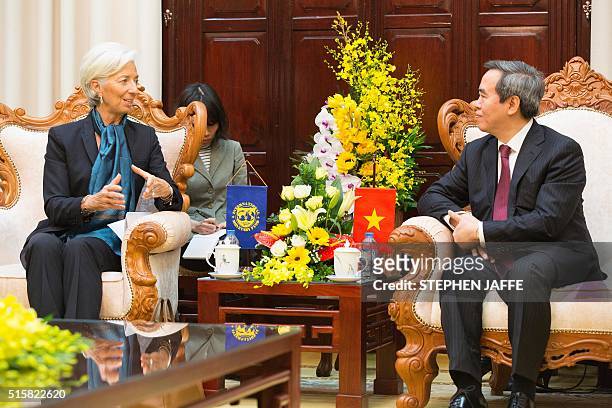 International Monetary Fund Managing Director Christine Lagarde talks with the Governor of the State Bank of Vietnam Nguyen Van Binh at the Banks...