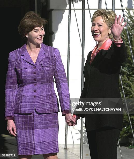 First Lady Hillary Clinton waves as she greets future First Lady Laura Bush 18 December 2000 at the White House in Washington DC. Both Mrs. Bush and...