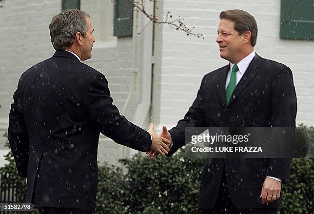 President-elect George W. Bush is greeted 19 December, 2000 by his presidential campaign opponent US Vice President Al Gore at Gore's Washington, DC...