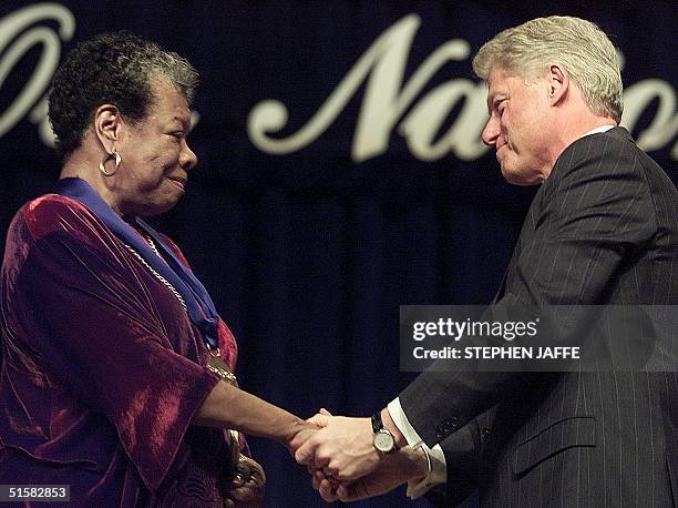 President Bill Clinton congratulates poet/writer Maya Angelou after presnting her with the National Medal of Arts during ceremonies 20 December, 2000...