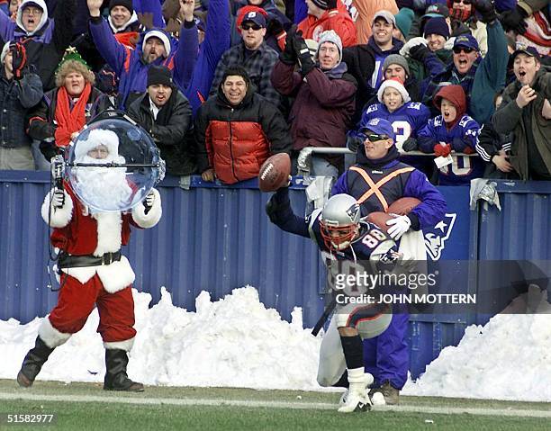 New England Patriots' wide receiver Terry Glenn celebrates with fans after scoring a touchdown seconds before the end of the first half against the...