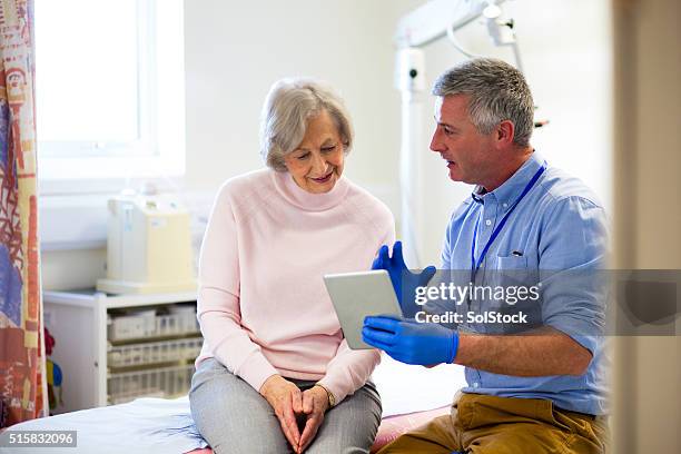 "here are your results..." - general practitioner stock pictures, royalty-free photos & images