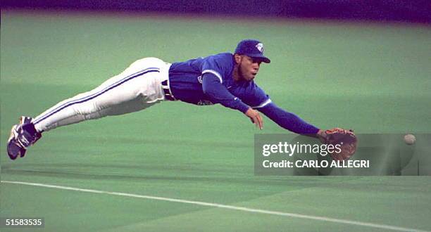 Toronto Blue Jays' player Roberto Alomar dives and misses a hit single by California Angels player Chili Davis in the second inning 30 April at the...