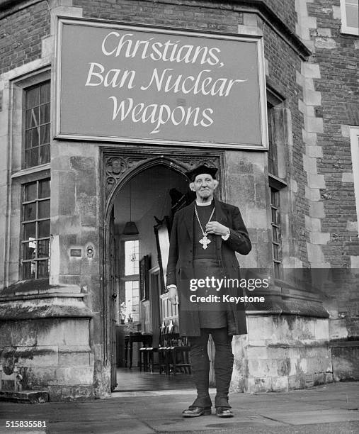 Reverend Dr Hewlett Johnson, Dean of Canterbury Cathedral, posing in front of a sign at the entrance of his Deanery, January 16th 1961.