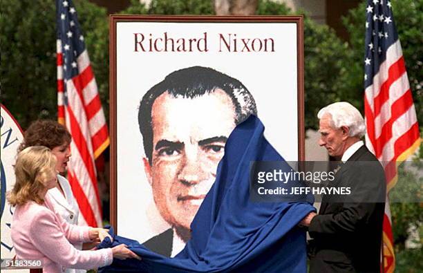 Julie Nixon Eisenhower, Trica Nixon Cox, daughters of Richard Nixon, and Postmaster General Marvin Runyon unveil the stamp 26 April honoring Richard...