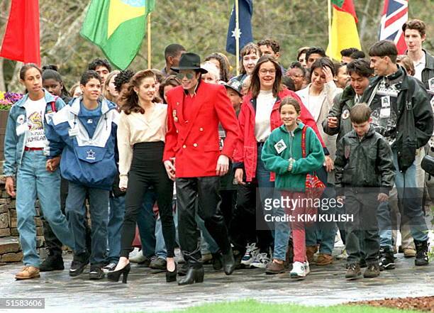 Pop superstar Michael Jackson , holding hands with his wife Lisa Marie Presley, walks with children at his Neverland Ranch in Los Olivos, California...