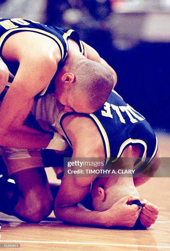 Indiana Pacers guard Reggie Miller (R) is hugged b