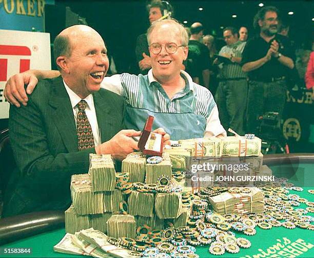 Jack Binion and Dan Harrington of Downey, California look over a mountain of cash and chips on Thursday after Harrington won the 1995 World Series of...