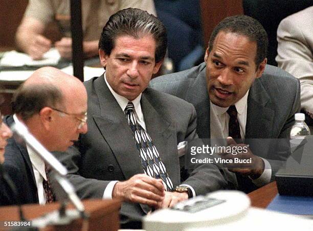 Murder defendant O.J. Simpson consults with friend Robert Kardashian and Alvin Michelson , the attorney representing Kardashian, during a hearing...