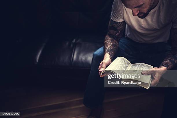 man reading bible - bible stock pictures, royalty-free photos & images