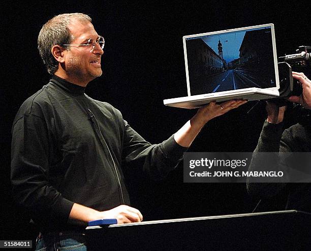 Steve Jobs, CEO of Apple Computer unveils a new titanium G4 Powerbook with a 15.2 inch screen during his keynote address at the MacWorld Expo in San...