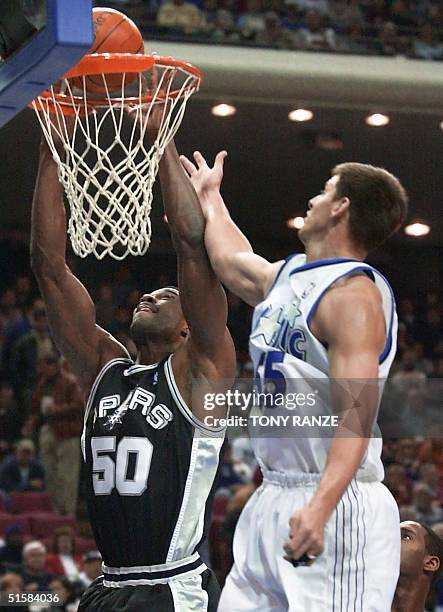 San Antonio Spurs center David Robinson is fouled by Orlando Magic center Andrew DeClercq during the first period 09 January 2001 at the TD...