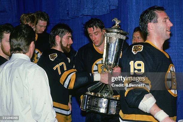 Canadian professional ice hockey players Ray Bourque and Cam Neely of the Boston Bruins lift the Prince of Wales Trophy which goes to the team which...