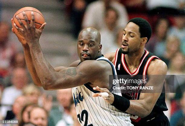 Orlando Magic center Shaquille O'Neal takes control of a Magic rebound from Miami Heat center Alonzo Mourning during the first period of their NBA...