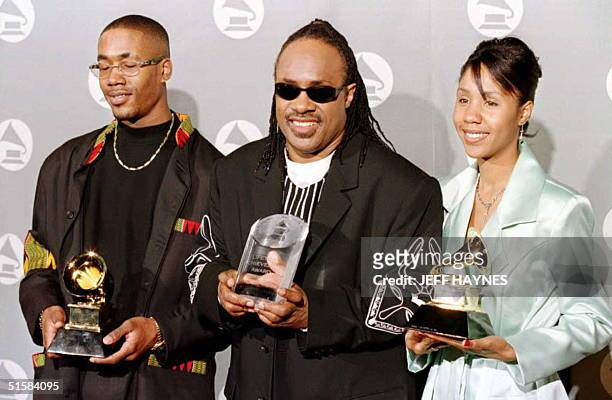 Musician Stevie Wonder holds a Lifetime Achievement award as his son Keita and daughter Aishia Morris hold his Grammy Awards for Best Male R & B...