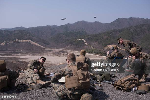 In a photo taken on March 15, 2016 US soldiers of the 31st Marine Expeditionary Unit provide support for an infantry live fire drill during an...