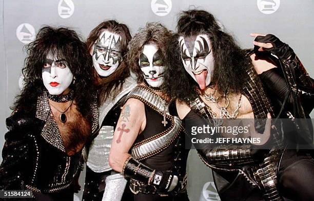 Members of the veteran rock group "KISS" pose for photographers in the photo room at the 38th Annual Grammy Awards in Los Angeles 28 February. The...