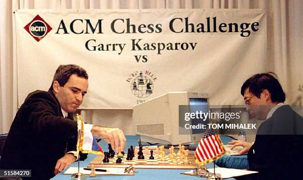 World chess champion Garry Kasparov, L, takes a pawn in the opening minutes of a six-game, six-day chess match against IBM's "Deep Blue" computer in...