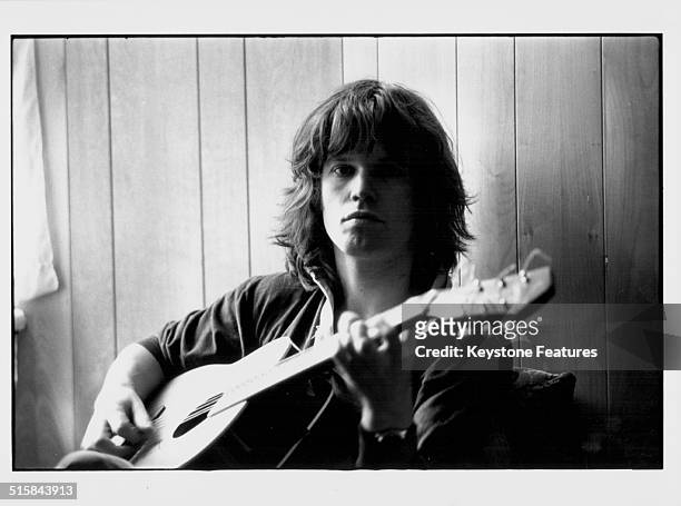 Portrait of musician Chris Jagger with his guitar, brother of pop singer Mick Jagger, circa 1968.
