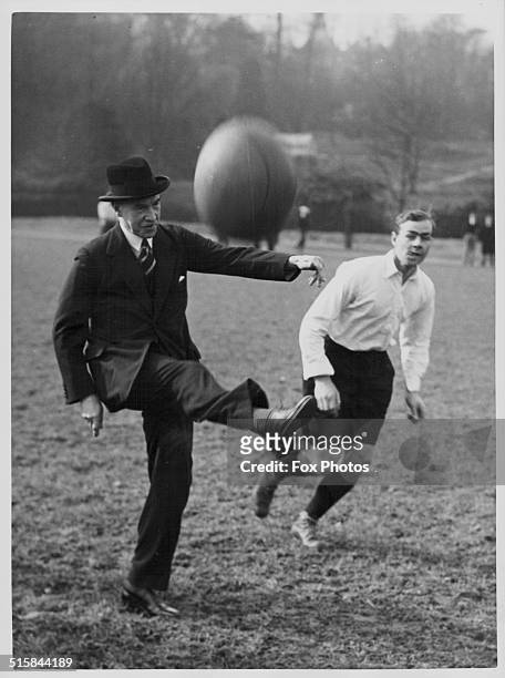 Sir Stanley Jackson taking part in a football match, as part of founders day at Harrow School, London, March 1936.