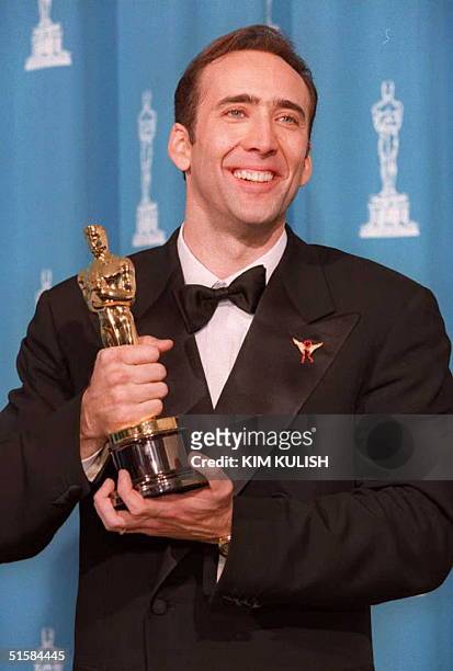 Nicolas Cage, the winner of Best Actor for his role as the self-destructive alcoholic Ben Sanderson in "Leaving Las Vegas," poses with his Oscar at...