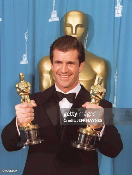 Mel Gibson holds Oscars for Best Director and Best Picture for "Braveheart," at the Dorothy Chandler Pavillion in Los Angeles 25 March 1996 at the...