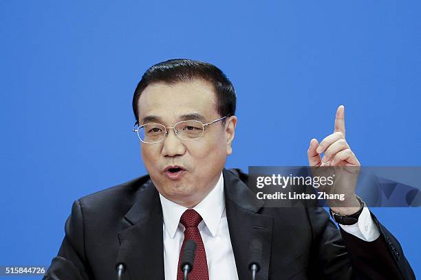 China's Premier Li Keqiang answers questions during the annual news conference following the closing session of the National People's Congress at the...