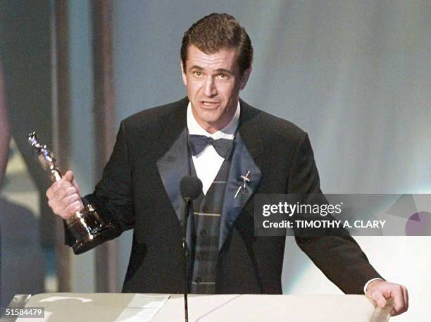 Actor and director Mel Gibson holds up his Oscar for Best Director for his film "Braveheart" at the 68th Academy Awards March 25, 1996 at the Dorothy...
