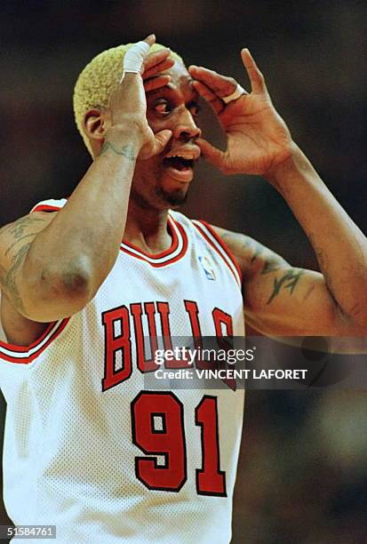 Dennis Rodman, forward for the Chicago Bulls, opens his eyes wide after throwing an airball during a free throw attempt in a game against the Detroit...