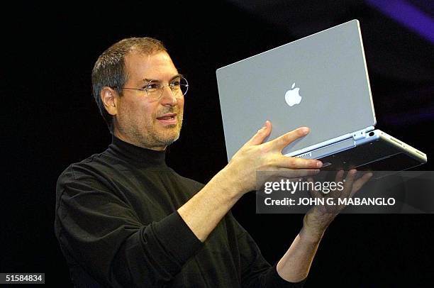 Steve Jobs, CEO of Apple Computer unveils a new titanium G4 Powerbook with a 15.2 inch screen during his keynote address at the MacWorld Expo in San...