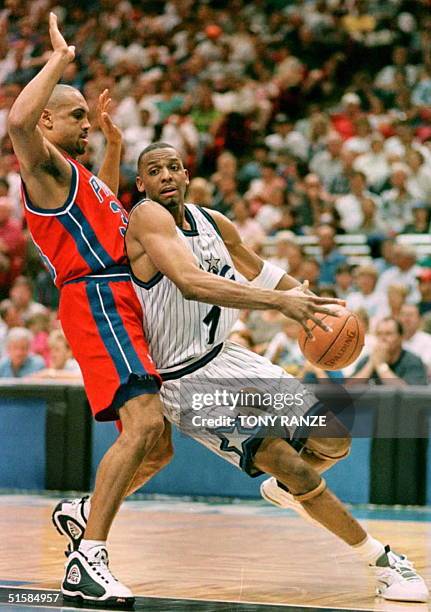 Orlando Magic guard Anfernee Hardaway drives past Detroit Pistons forward Grant Hill during the second period of their first round playoff game at...