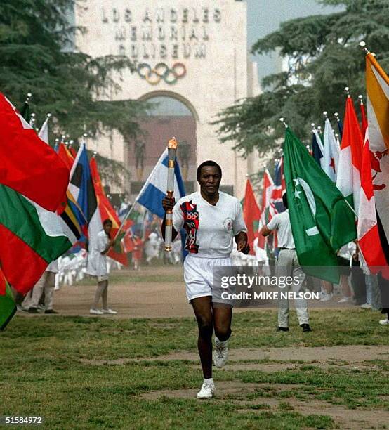 Olympic Decathlon Gold Medalist Rafer Johnson, of the US, leaves the Olympic Flame ceremony 27 April at the Los Angeles Memorial Coliseum. Johnson...