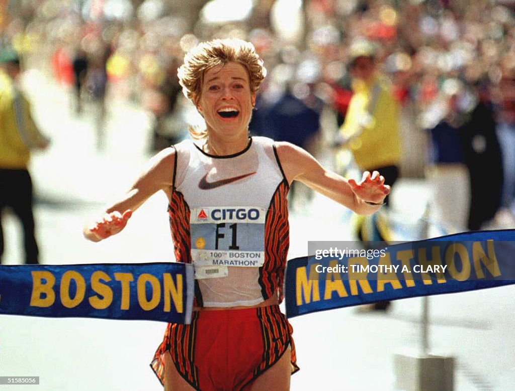 Uta Pippig of Germany crosses the finish line to w