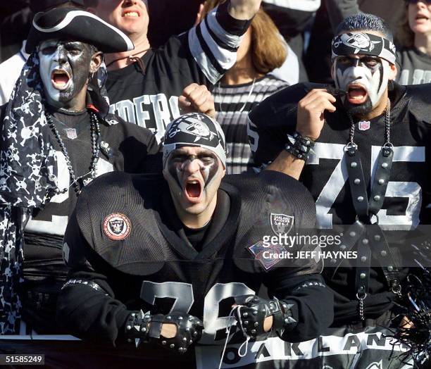 Oakland Raiders fans cheer in the stands during their AFC Championship game against the Baltimore Ravens in the first quarter, 14 January at the...