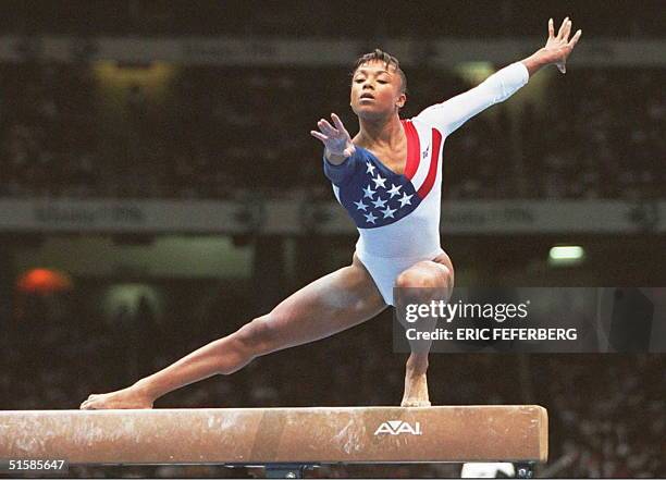 Olympic team gymnast Dominique Dawes practices on the balance beam during a training session 16 July at the Georgia Dome in Atlanta. The 26th Summer...