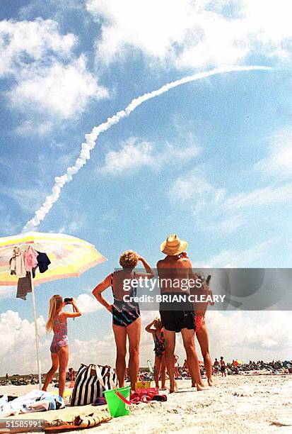 The Brutscher family of Inidalantic, Florida watch the Space Shuttle Columbia blast off into space from the Kennedy Space Center as they enjoy a...