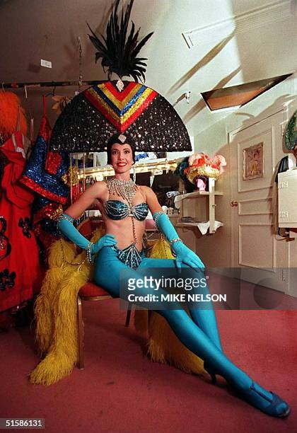 Showgirl Kristine Daniells-Silva from Tonopah, Nevada, poses after putting on her make-up and Gold and Blue costume for the live dance revue "Les...