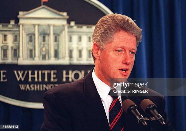 President Bill Clinton speaks 27 July at a brief press conference to address the bomb blast that ripped through Atlanta's Olympic Centennial Park...