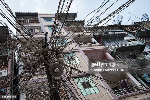 Entangled electric wires dangle in a Yangon street.