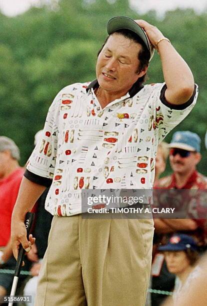 Jumbo Ozaki, of Japan, reacts to missing a putt on the tenth hole 14 September during the Presidents Cup golf tournament at the Robert Trent Jones...