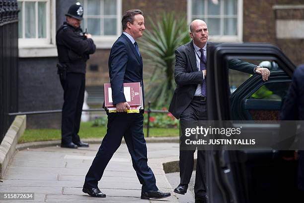 British Prime Minister David Cameron leaves 10 Downing Street in London, on March 16 as British Chancellor of the Exchequer George Osborne prepares...